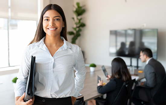 Hispanic female business professional in office boardroom